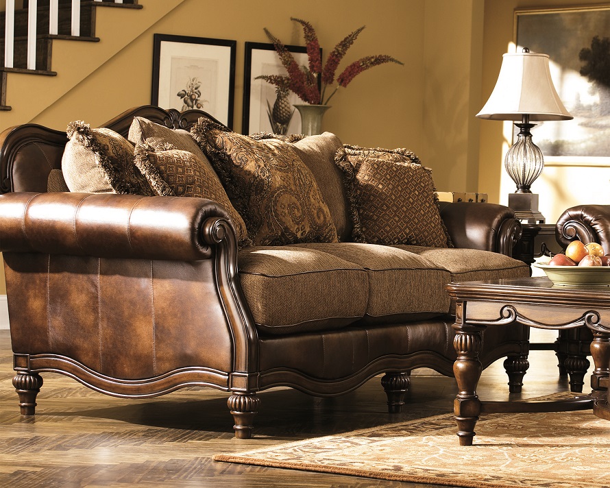 Rich Classic Antique Brown Couch Wrapped in Leather Like Roll Arms and Soft Chenille Seating