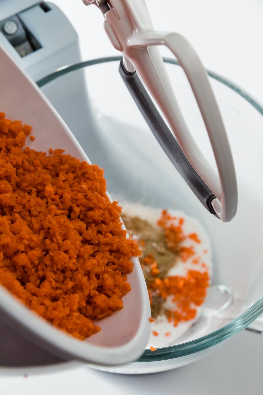 Carrots being adding to carrot cake batter