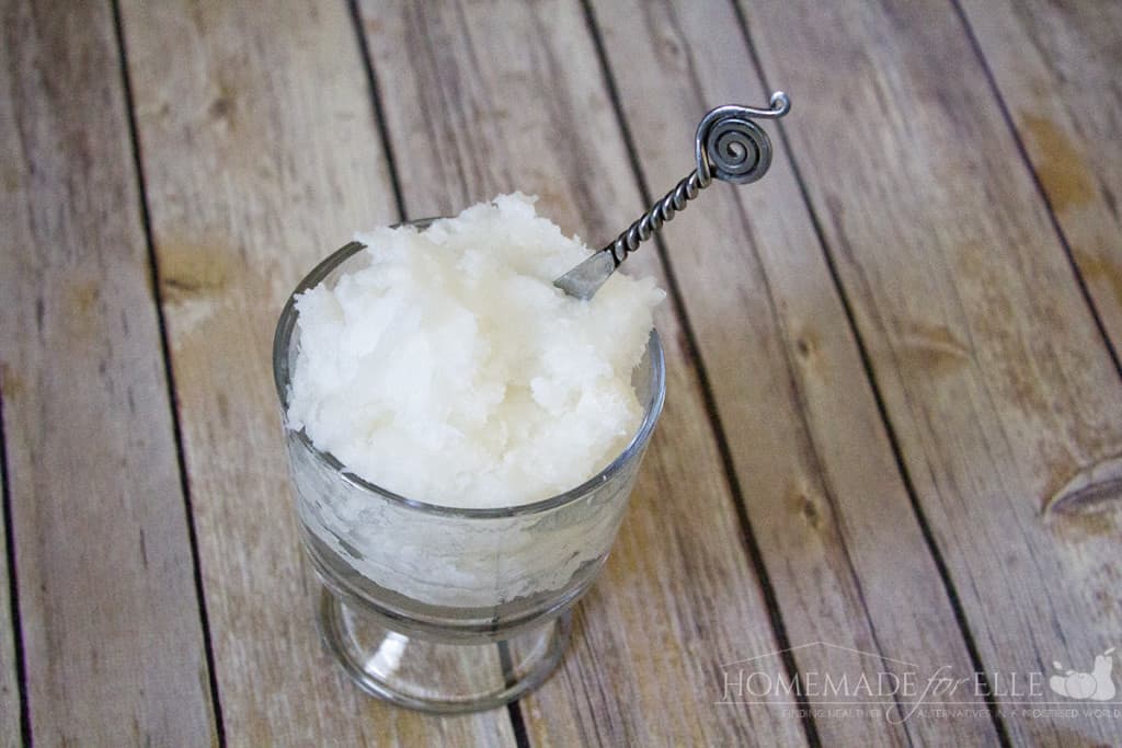 Coconut oil in a glass bowl on a wood surface