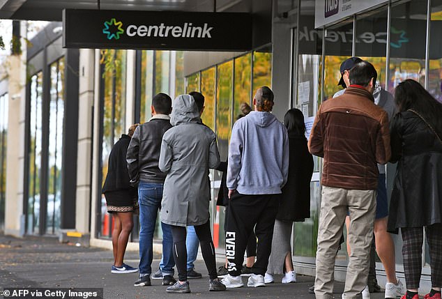 On Tuesday Scott Morrison announced the JobSeeker payment, which currently helps 3.5million Australians, would be reduced in phases as the economy recovers from coronavirus lockdown (pictured: dozens of people lining up outside Centrelink in Melbourne in April)
