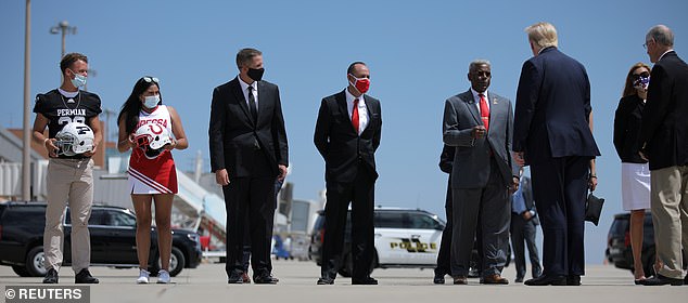 Many of the officials greeting President Trump in Texas wore face masks