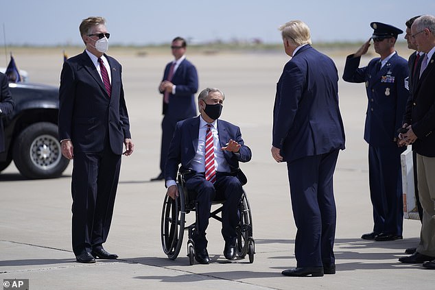 Republican Gov. Greg Abbott of Texas greets President Trump while wearing a face mask